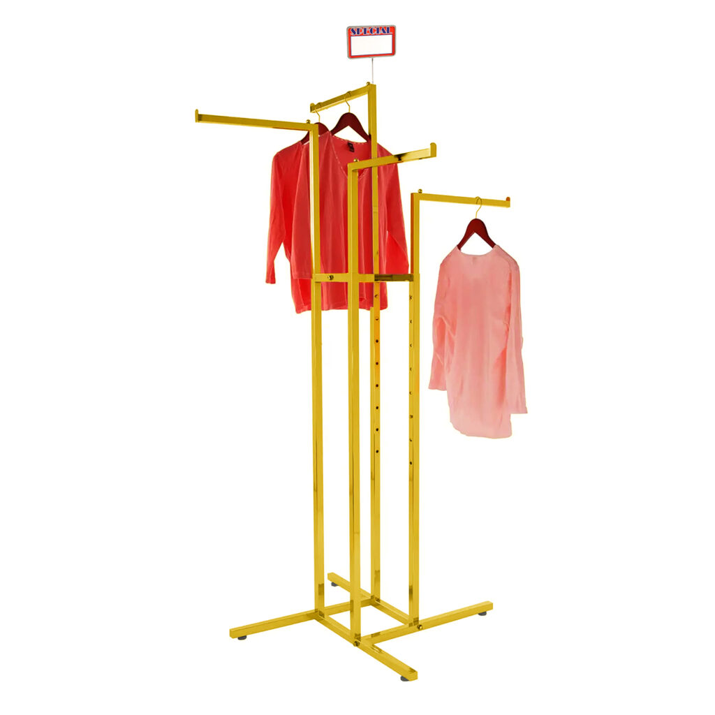 Four-way clothing display rack in gold finish with curated designer outfit presentation