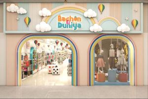 Wall-mounted adjustable shelving system displaying folded children's clothes in pastel colors