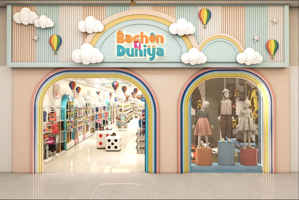 Wall-mounted adjustable shelving system displaying folded children's clothes in pastel colors