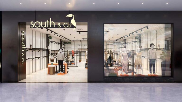 Wide view of modern fashion clothing store with metal display racks and mannequin display setup