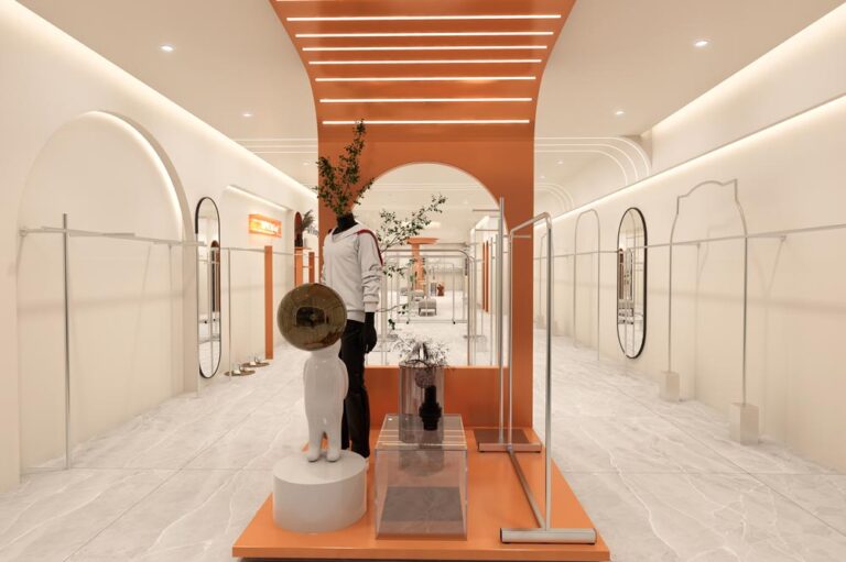 Fashion store entrance display area with mannequins and custom display stands