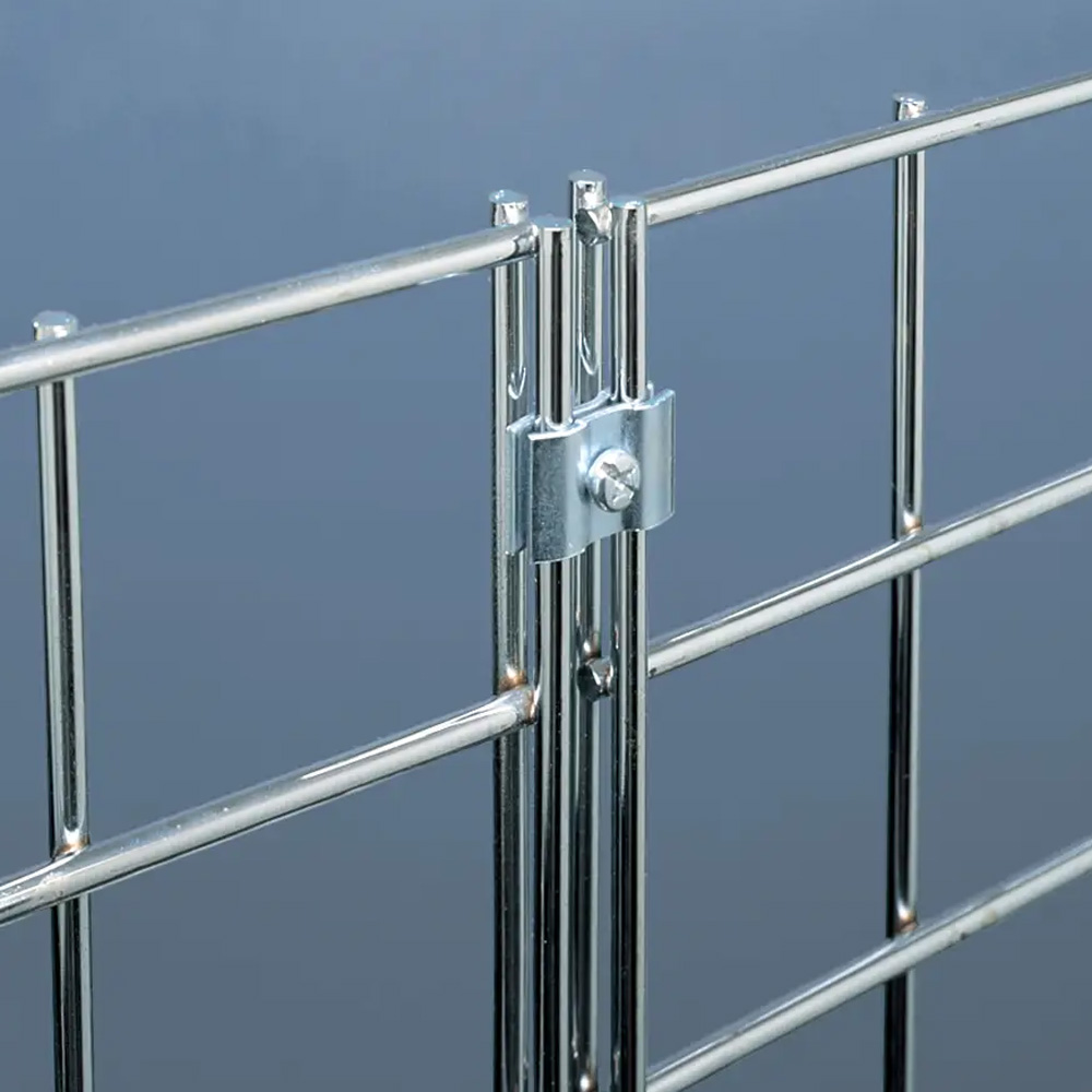 Close-up detail shot of a black metal butterfly clip securely clamping two wire grid panels together.