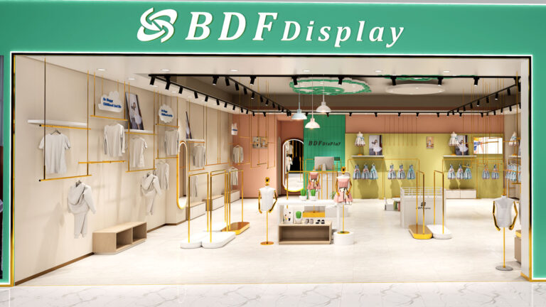 Close-up of central white display platform with kid mannequin, potted cacti, and brushed gold garment rack by BDFDisplay
