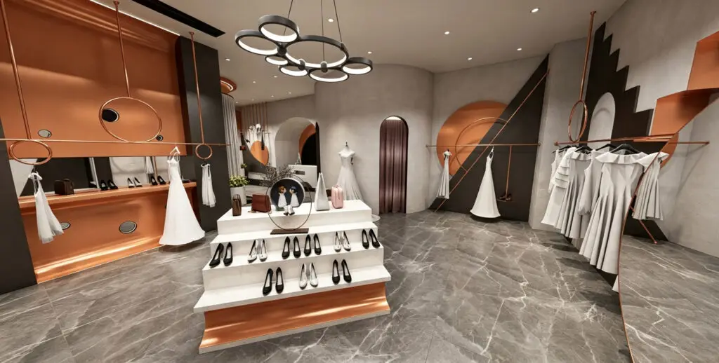 Minimalist white reception counter and custom rose gold hanging garment displays.