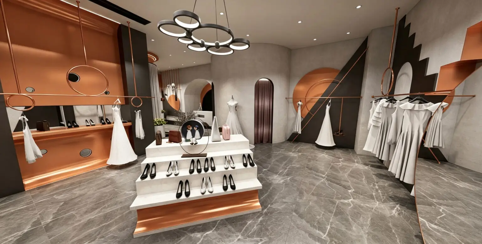 Minimalist white reception counter and custom rose gold hanging garment displays.