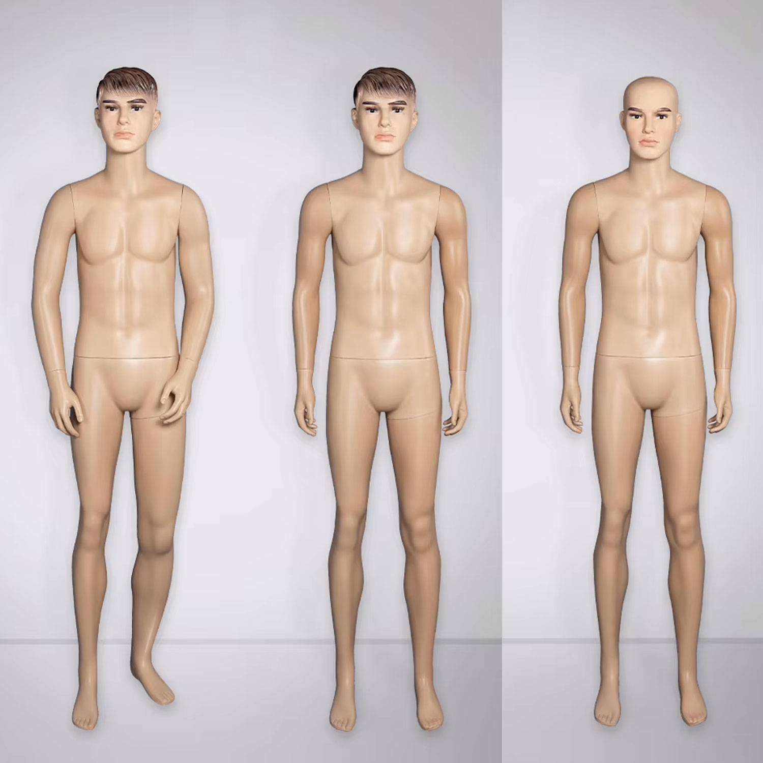 Realistic male plastic mannequins displayed in studio showroom setting